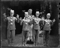 "Hansel and Gretel" cast member Barbara Ludwig with gingerbread children, Barnum Hall, Santa Monica, 1957