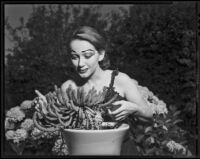 Betty Herrick posing with a potted cactus, 1953