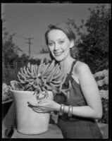 Betty Herrick outdoors with potted cactus, 1953