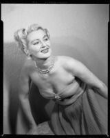 Ruth Crandall modelling an evening dress, Santa Monica, circa 1955