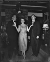 Betty Herrick with 2 unidentified men in a living room, 1955