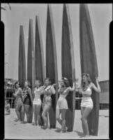 Salt Water Carnival queen’s court posed with longboards, Santa Monica Beach, 1941