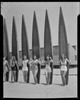 Salt Water Carnival queen’s court posed with longboards, Santa Monica Beach, 1941