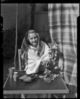 Santa Monica College student Carleen Andrews holding a string of beads, Santa Monica, 1935