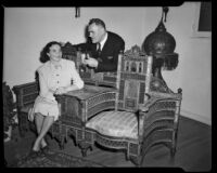 Man and woman in a room with Egyptian furnishings at a home in Santa Monica Canyon, Los Angeles, 1950