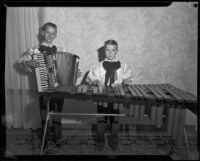 Musselman boys standing with accordion and xylophone, 1950