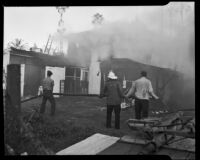 Firemen battling a fire on the property of Jack Donovan, Santa Monica, 1953