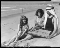 Eugene d'Orange telling Valeska Radd and June Diebold their fortunes, Santa Monica, 1931