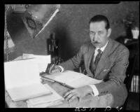 Eugene d'Orange studying notebooks, Santa Monica, 1931