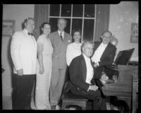 Pianist seated at a piano with 3 men and 2 women standing behind him, Santa Monica, 1951 or 1952