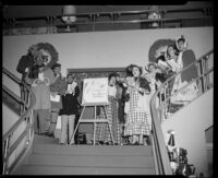 Santa Monica Civic Opera performers sing Christmas carols at Bullock's department store, Westwood, 1955