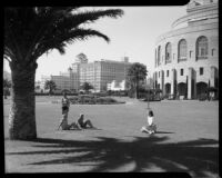 Children and a young woman in the garden at the Municipal Auditorium, Long Beach, circa 1940