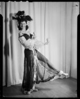 Lucille G. Maser in rumba costume with maracas, Los Angeles, 1941