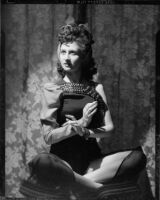 Lucille Maser seated on a cushion, Santa Monica, circa 1941