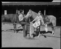 Helen Willard and a cowboy at a horse stable at the La Paz Guest Ranch, Palm Springs, 1941