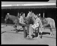 Helen Willard and a cowboy at a horse stable at the La Paz Guest Ranch, Palm Springs, 1941