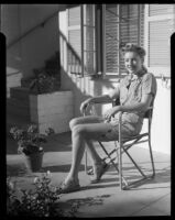 Mona Ohrtland seated in a patio, Palm Springs, 1940