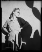 Mona Ohrtland standing against a wall next to a cactus shadow, Palm Springs, 1940