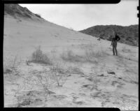Girl, perhaps Carolyn Bartlett, standing on a sandy slope, Palm Springs vicinity