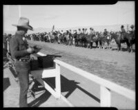 Equestrians lined up on the track during a rodeo at the Palm Springs Field Club, circa 1941
