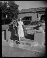 Shirlee Baker, model, standing in front of the Casa Madre residence, Los Angeles, 1951