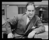 H. Malin Campbell seated at his desk, Santa Monica, 1939