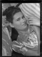 Janet Roob or Mary Lou Warner reclining on pillow, Santa Monica, 1946-1950