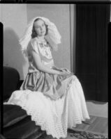 Carolyn Bartlett wearing a silk blouse and skirt and a cotton lace headdress, Santa Monica, 1938