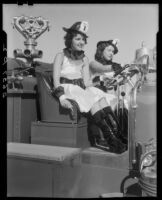 Two young women seated at the steering wheel of a Santa Monica Fire Department truck after winning a contest, Santa Monica, 1934