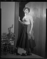 Diane Dali Kortz standing in a doorway, Santa Monica, 1954