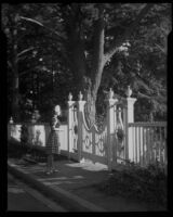 Evelyn Most at a gated entrance, possibly Pacific Palisades or Santa Monica, 1944