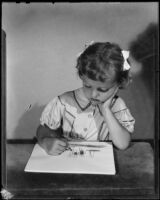 Anne Marie Williams coloring at a table, 1942