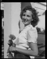 Margaret Barge holding a flower at Palisades Park, Santa Monica, 1946