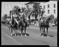 Actor William S. Hart and son (possibly) on horseback in the California Admission Day Parade, Santa Monica, 1937