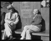 Mayor Edmond Gillete and actor Charles Grapewin seated on the Louis B. Mayer Memorial Bench, Palisades Park, Santa Monica, 1937