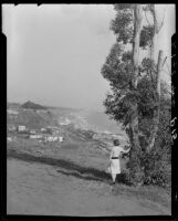 Woman on a Huntington Palisades bluff looking towards Santa Monica Canyon and Santa Monica Bay, 1924