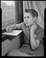 Boy seated at a window sketching at the Children's Home Society, Los Angeles, 1935-1960