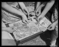 Close-up view of girls working on a jigsaw puzzle at the Children's Home Society, Los Angeles, 1935-1960