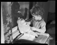 Little girl playing with doll as another girl watches at the Children's Home Society, Los Angeles, 1935-1960