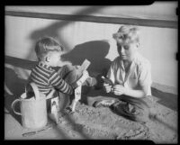 Two boys planting flower seeds at the Children's Home Society, Los Angeles, 1935-1960