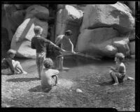 Boys playing in a shallow pool of water, Matilija Canyon, Ojai vicinity, 1940s