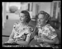 Lee sisters seated on metal chairs on a porch, 1938