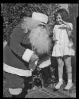Santa Claus and little girl in front of Adelbert Bartlett's house, Santa Monica, 1938