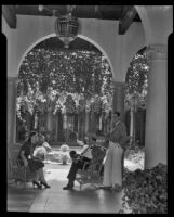 Woman and two men in the patio of El Mirasol Hotel, Santa Barbara, 1941
