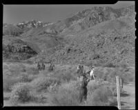 Betty Shafer with horseback riders in a desert landscape, Palm Springs vicinity, 1942
