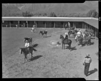 Guests and horses in the corral at the Rogers Ranch resort, Palm Springs, 1941