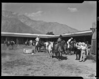 Men on horses in the corral at the Rogers Ranch resort, Palm Springs, 1941