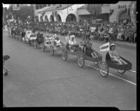 Procession of two-wheeled carts on Palm Drive in the Desert Circus Parade, Palm Springs, 1946