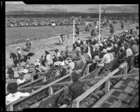 Horseback riders on the track of the Palm Springs Field Club during the Desert Circus Rodeo, Palm Springs, 1946
