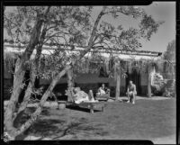 People relaxing in the garden of a house, Palm Springs, 1935